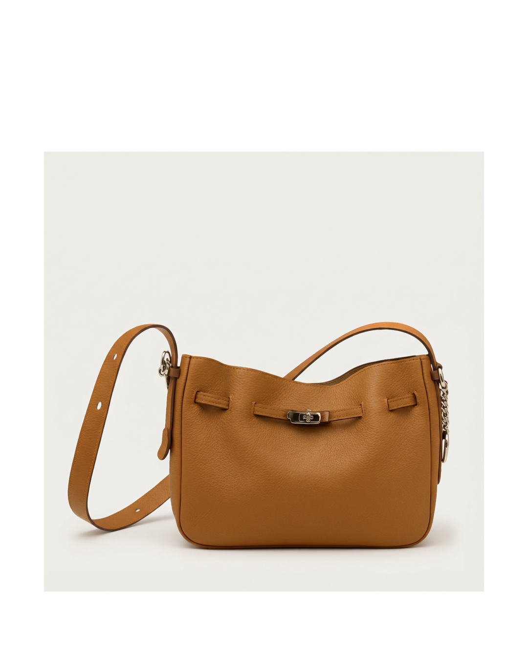 Brown leather handbag with a strap on a light gray background